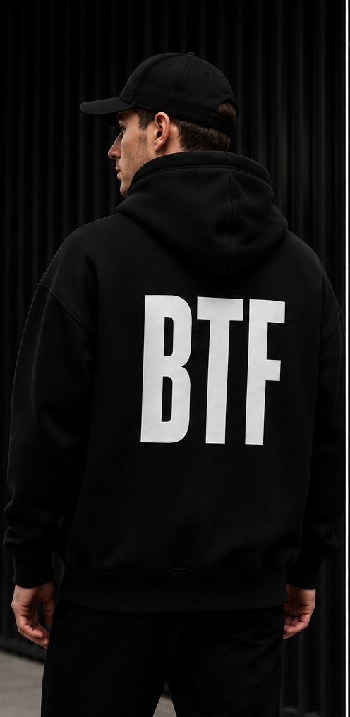 Person wearing the black BTF hoodie seen from behind with the BTF wordmark across the back